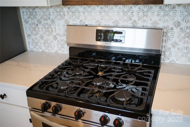 133 Water Leaf Dr, Weaverville, NC 28787 - kitchen view of stainless steel range with gas cooktop, backsplash, and light countertops