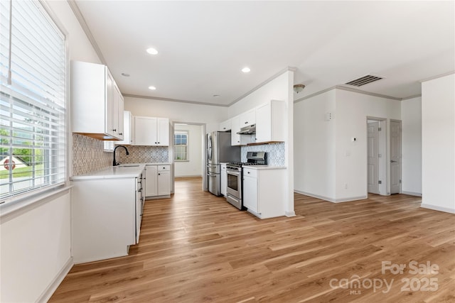 133 Water Leaf Dr, Weaverville, NC 28787 - kitchen featuring appliances with stainless steel finishes, a sink, light countertops, crown molding, and tasteful backsplash
