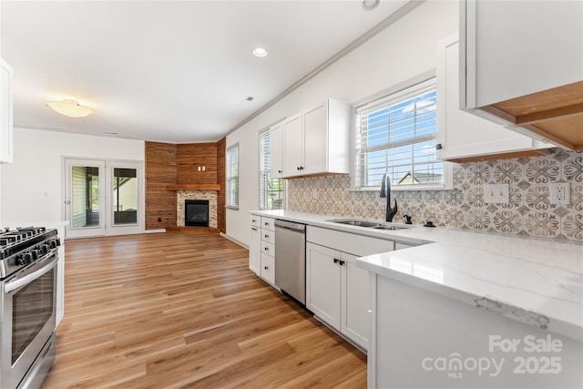 133 Water Leaf Dr, Weaverville, NC 28787 - kitchen featuring stainless steel appliances, a sink, open floor plan, white cabinetry, and backsplash