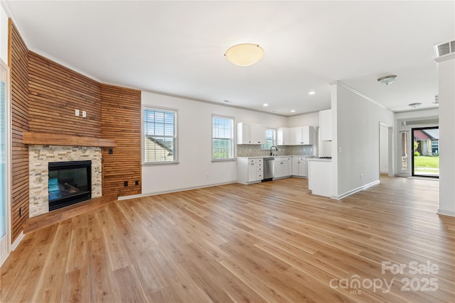 133 Water Leaf Dr, Weaverville, NC 28787 - unfurnished living room featuring ornamental molding, light wood-style flooring, baseboards, a fireplace, and recessed lighting