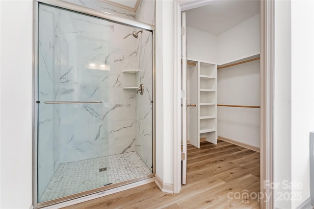133 Water Leaf Dr, Weaverville, NC 28787 - full bathroom with wood finished floors, a marble finish shower, a walk in closet, and baseboards