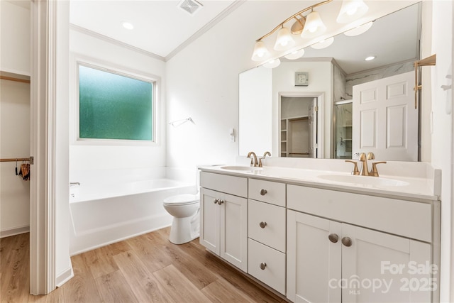 133 Water Leaf Dr, Weaverville, NC 28787 - bathroom featuring crown molding, wood finished floors, a stall shower, double vanity, and a spacious closet