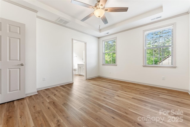 133 Water Leaf Dr, Weaverville, NC 28787 - unfurnished bedroom featuring a raised ceiling, light wood-style floors, baseboards, connected bathroom, and ceiling fan