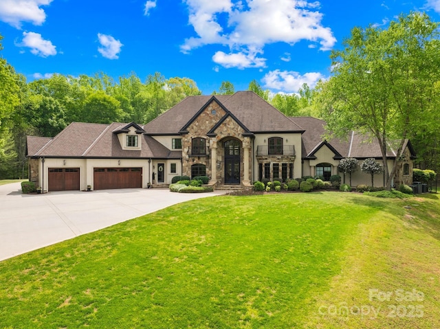 8451 Ridgewood Rd, Sherrills Ford, NC 28673 - french provincial home featuring a front lawn, stone siding, stucco siding, an attached garage, and driveway