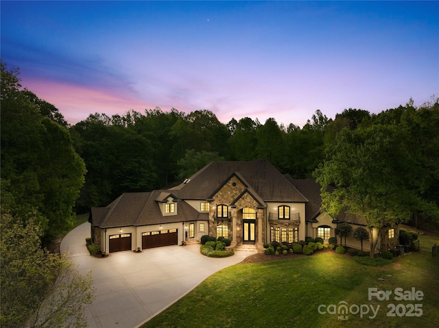 8451 Ridgewood Rd, Sherrills Ford, NC 28673 - french country inspired facade with an attached garage, a front lawn, stone siding, french doors, and driveway