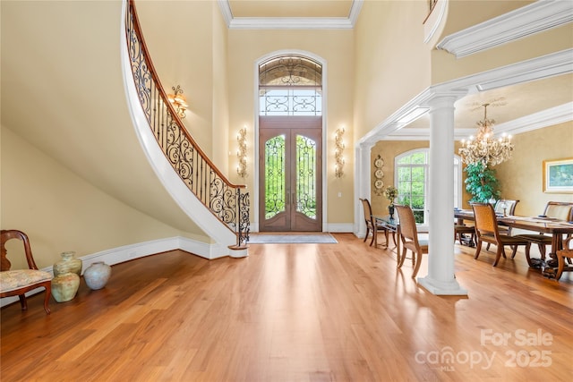 8451 Ridgewood Rd, Sherrills Ford, NC 28673 - entrance foyer with a chandelier, stairs, wood finished floors, a towering ceiling, and ornate columns