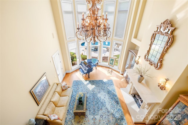 8451 Ridgewood Rd, Sherrills Ford, NC 28673 - living room featuring a notable chandelier, wood finished floors, and a towering ceiling