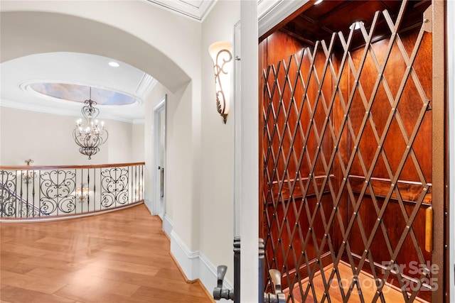 8451 Ridgewood Rd, Sherrills Ford, NC 28673 - corridor with an inviting chandelier, arched walkways, baseboards, wood finished floors, and ornamental molding