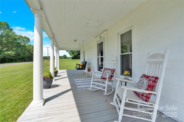 deck with a yard and covered porch
