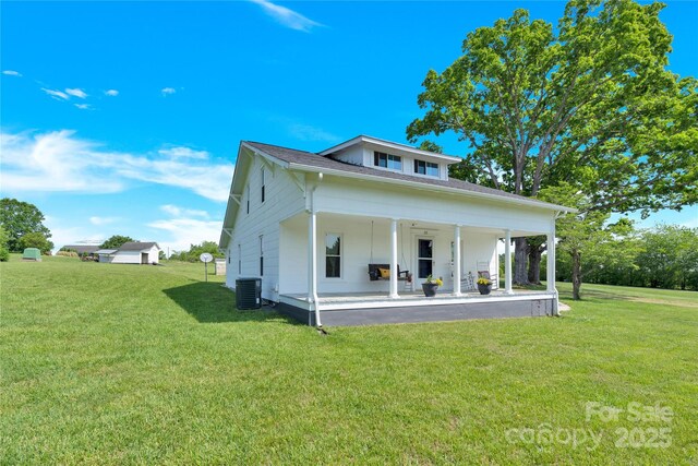 view of front facade with central AC unit, a front lawn, and a patio area