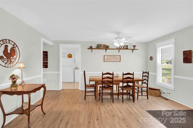dining room featuring a ceiling fan and light wood-type flooring