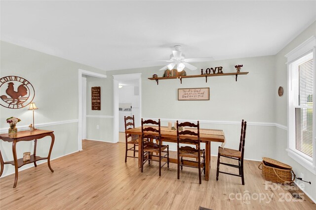 dining area with light wood-style floors and ceiling fan
