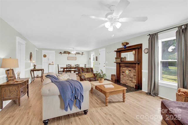 living area featuring a ceiling fan and light wood-style flooring