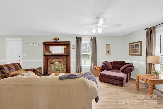 living area with a ceiling fan and light wood finished floors