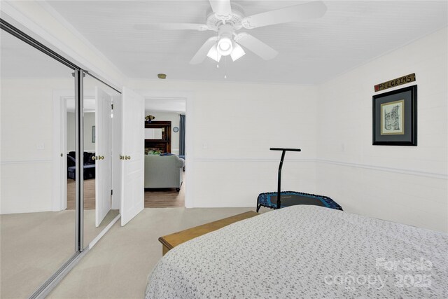 carpeted bedroom featuring a closet and ceiling fan