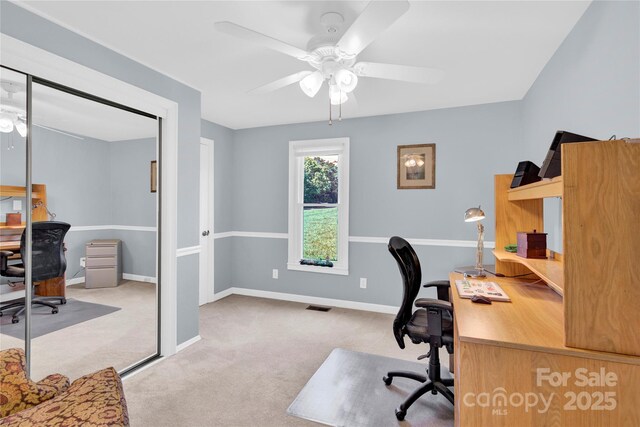 office featuring visible vents, a ceiling fan, baseboards, and carpet flooring