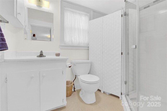 bathroom with vanity, tile patterned floors, a shower stall, and toilet