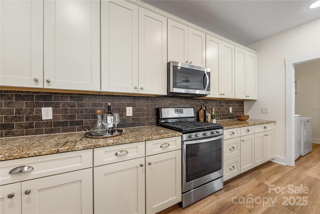 2638 Double Oaks Rd, Charlotte, NC 28206 - kitchen featuring stainless steel appliances, washer and dryer, light wood-style flooring, decorative backsplash, and light stone countertops
