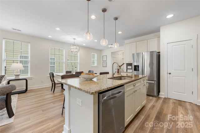 2638 Double Oaks Rd, Charlotte, NC 28206 - kitchen featuring a sink, stainless steel appliances, white cabinetry, light wood-type flooring, and recessed lighting