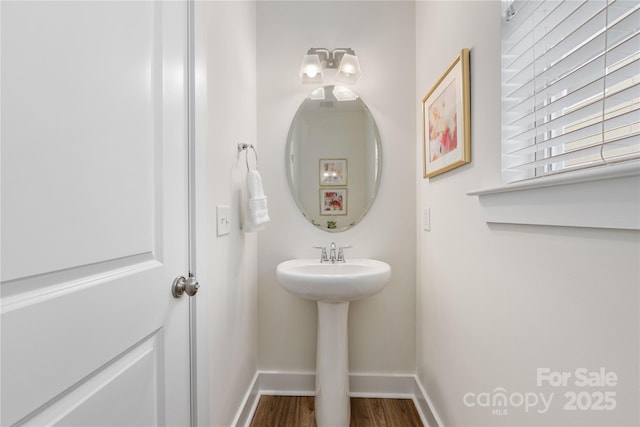 2638 Double Oaks Rd, Charlotte, NC 28206 - bathroom featuring baseboards, wood finished floors, and a sink