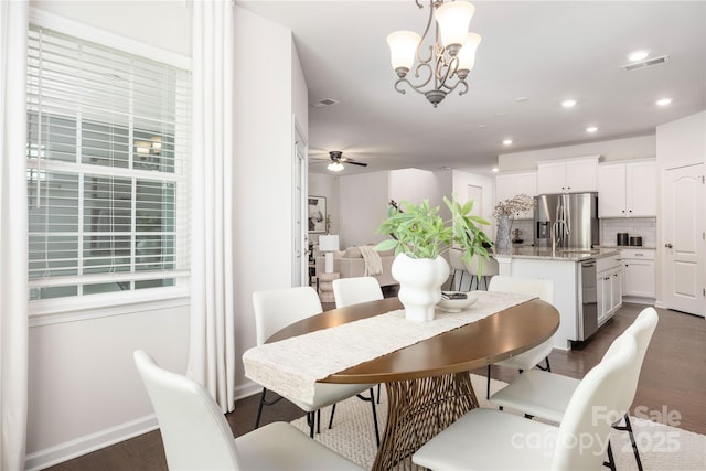 dining area featuring dark wood-style floors, a ceiling fan, recessed lighting, baseboards, and a chandelier