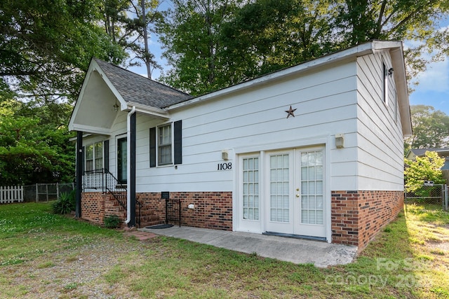 1108 Old Dallas Hwy, Dallas, NC 28034 - view of home's exterior with a lawn, fence, french doors, and brick siding