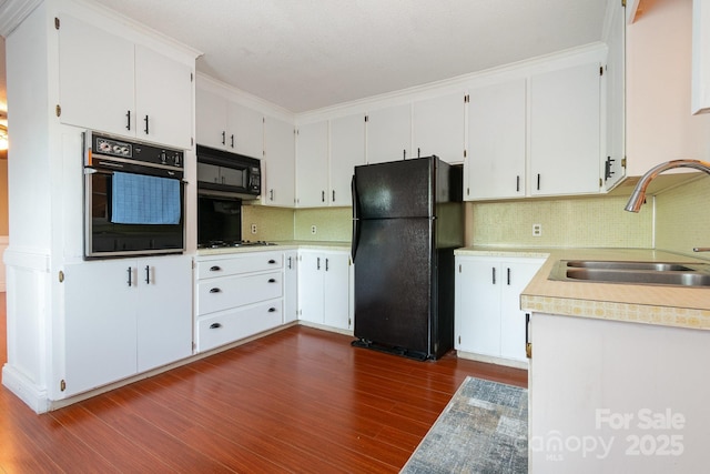 1108 Old Dallas Hwy, Dallas, NC 28034 - kitchen with a sink, light countertops, dark wood finished floors, tasteful backsplash, and black appliances