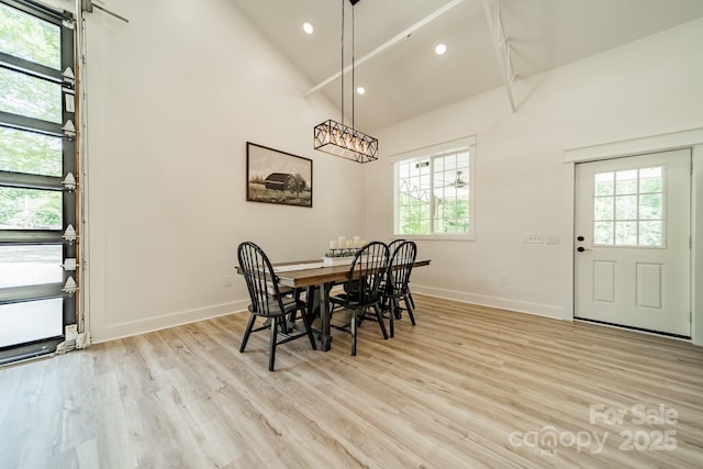 dining room featuring baseboards, recessed lighting, light wood-style floors, and high vaulted ceiling