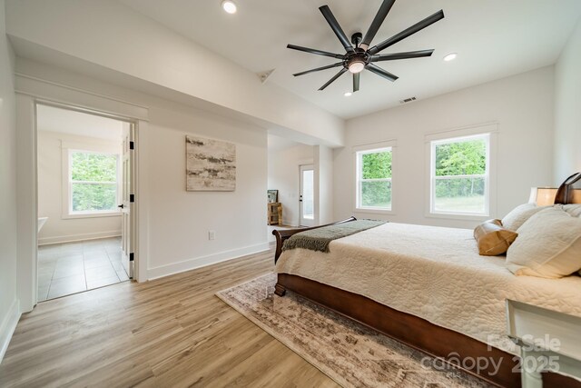 bedroom featuring light wood-style floors, multiple windows, recessed lighting, and visible vents