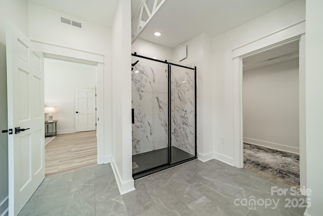 full bath featuring a marble finish shower, marble finish floor, recessed lighting, and visible vents