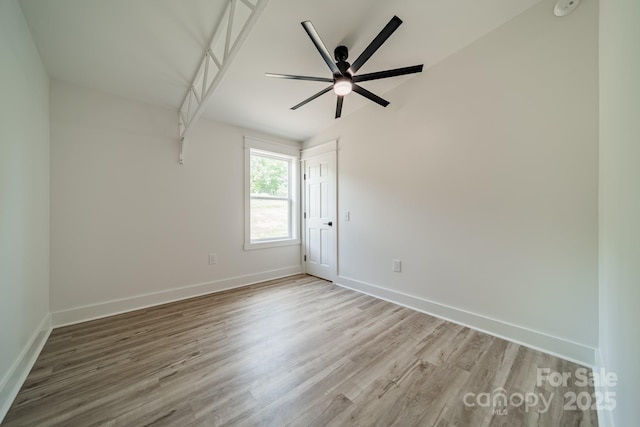 unfurnished room featuring a ceiling fan, baseboards, and wood finished floors