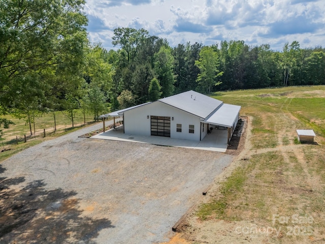 exterior space featuring a wooded view