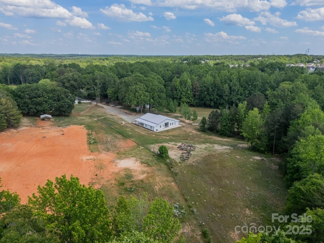 aerial view with a rural view and a wooded view