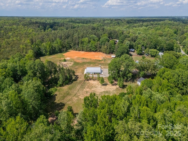 birds eye view of property with a view of trees