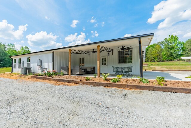 view of front of property featuring an outdoor living space, a ceiling fan, a patio area, and central AC unit