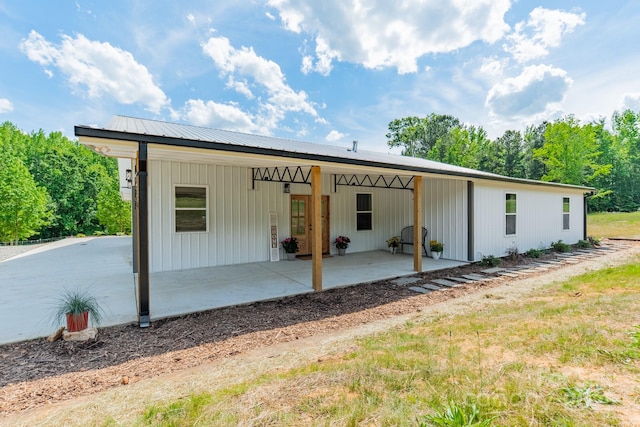 back of property with a patio area and an attached carport