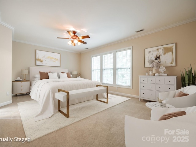 bedroom with light colored carpet, ornamental molding, and baseboards