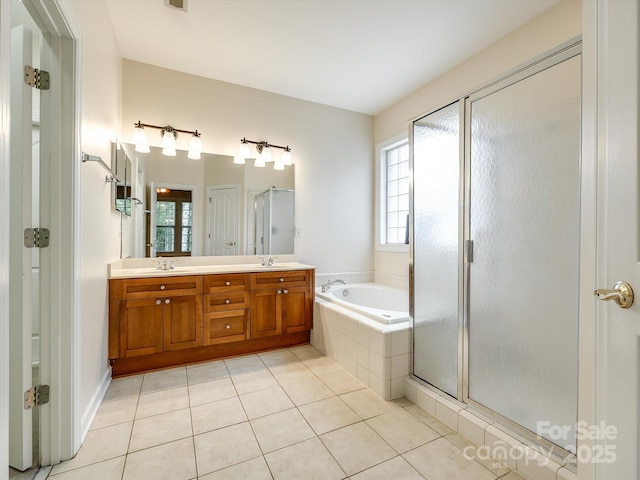 full bathroom featuring a sink, tile patterned floors, a shower stall, and a garden tub