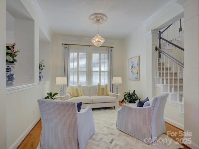 living area featuring crown molding, an inviting chandelier, light wood-style flooring, and stairway