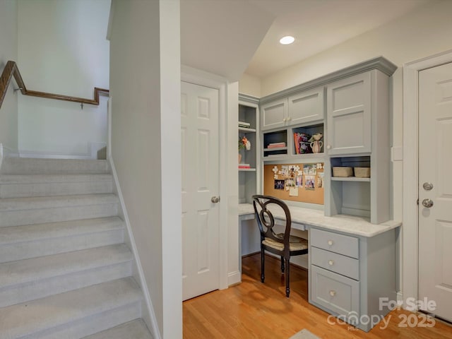 office featuring light wood-type flooring, recessed lighting, and built in desk