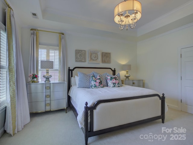 bedroom with a raised ceiling, crown molding, an inviting chandelier, and carpet
