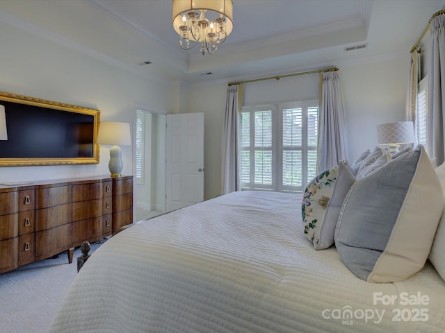 carpeted bedroom with crown molding, visible vents, an inviting chandelier, and a raised ceiling