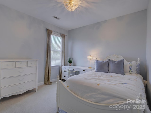 bedroom featuring baseboards, light colored carpet, and visible vents