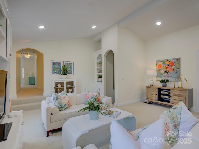 living room featuring light colored carpet, arched walkways, recessed lighting, baseboards, and vaulted ceiling