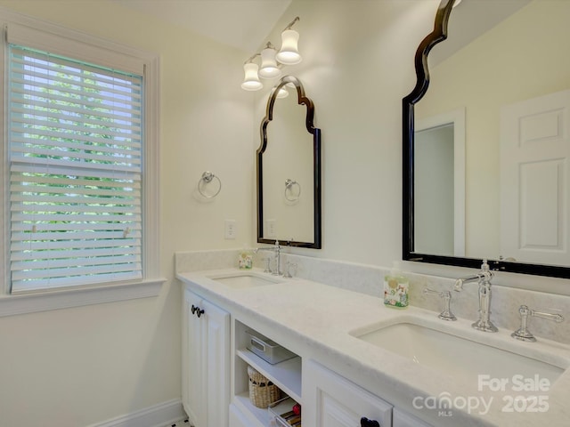 bathroom featuring a sink and double vanity