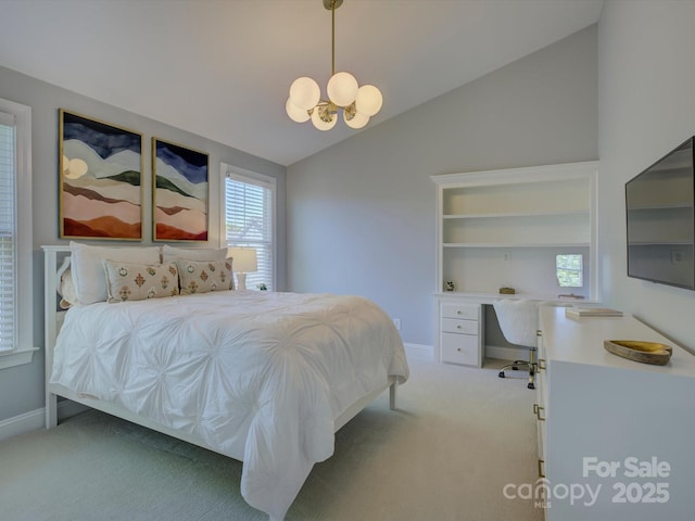 bedroom featuring carpet, multiple windows, a chandelier, and vaulted ceiling