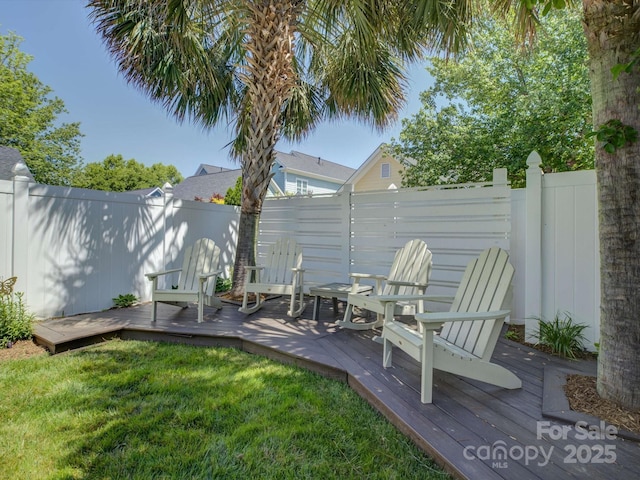 view of yard featuring fence and a deck