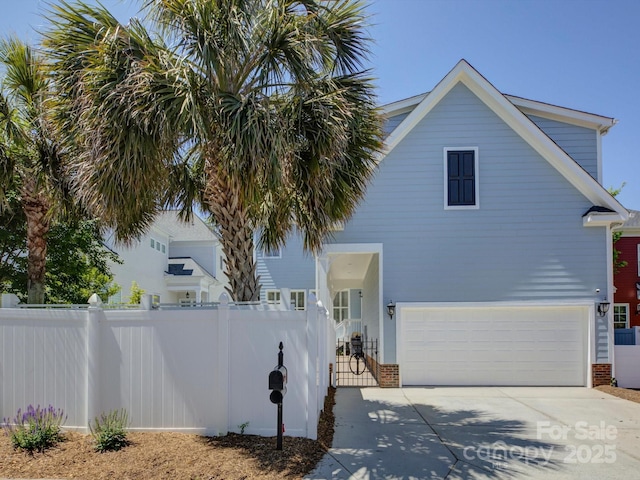 view of side of home with brick siding, an attached garage, fence, and driveway