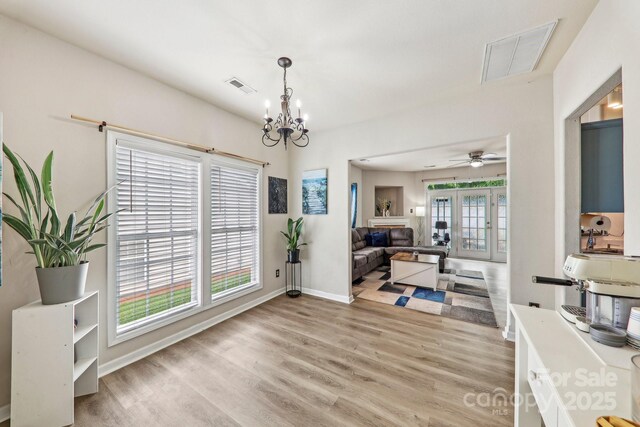 8259 Carob Tree Ln, Charlotte, NC 28215 - dining room featuring light wood finished floors, a chandelier, baseboards, and ceiling fan