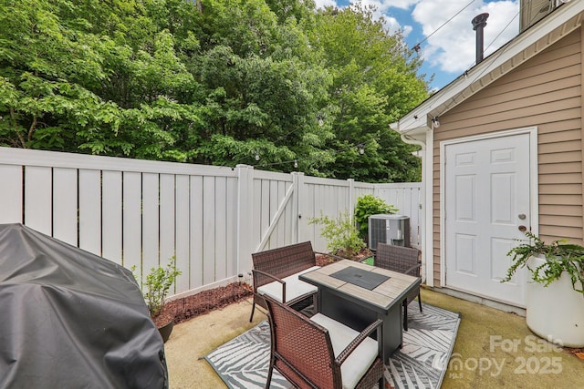 8259 Carob Tree Ln, Charlotte, NC 28215 - view of patio with outdoor dining area, central AC unit, a grill, and a fenced backyard